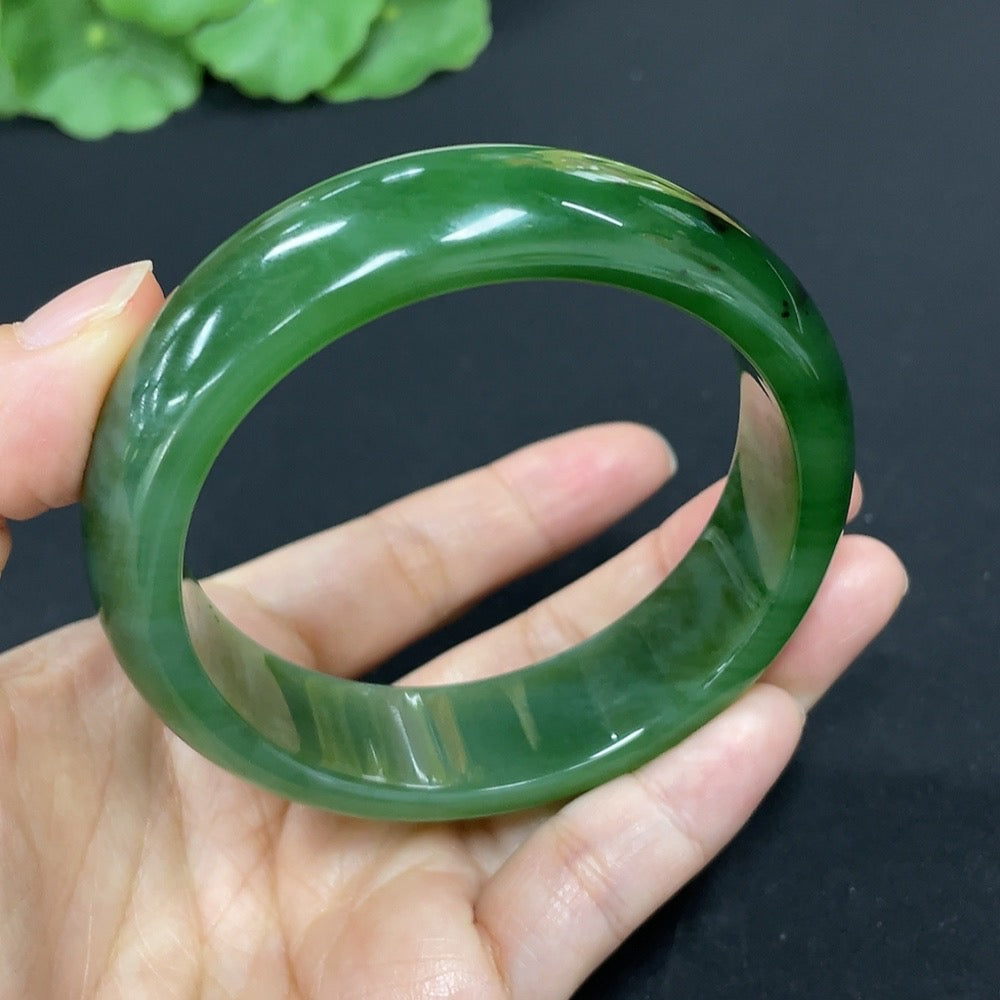 Green Hetian Jade round bangle bracelet by HKHQ featuring smooth, polished jade with a glossy finish and traditional craftsmanship.
