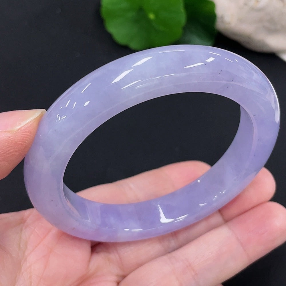 Jadeite round bangle with size 55.8 and weight 63g, crafted from smooth green jade, displayed on a neutral background.