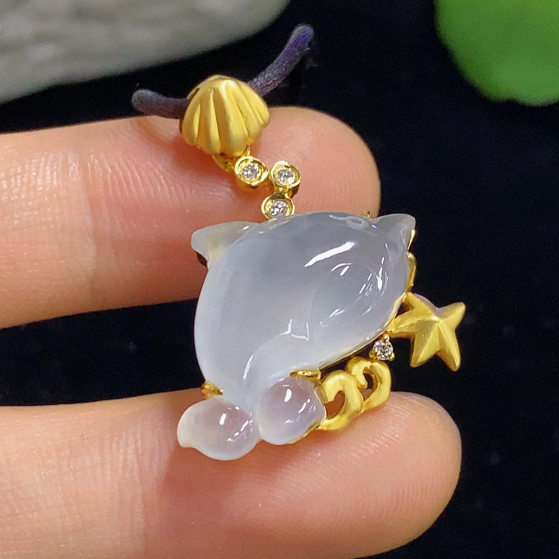 Jadeite inlaid pendant with 18K gold, diamond accents, featuring a jade gemstone, from HKHQ, weighing approximately 7.1g.