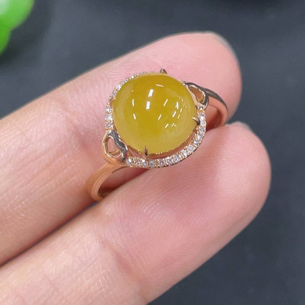 Jadeite cabochon ring in 18k gold setting with diamond accents, size 12.5, worn on a finger, weight approximately 2g.