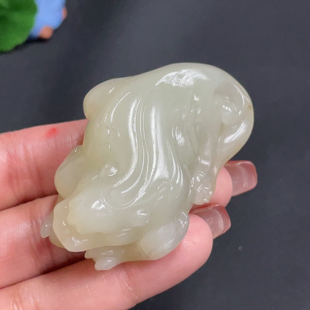 Huiliu Certified Hetian jade pendant featuring an auspicious beast carving, natural skin color, detailed craftsmanship.