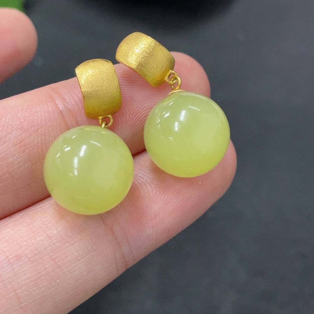 Hetian Jade inlaid earrings with 18K gold settings, approximately 11.8mm in size, weight 5.7g, by HUILIU HQ.