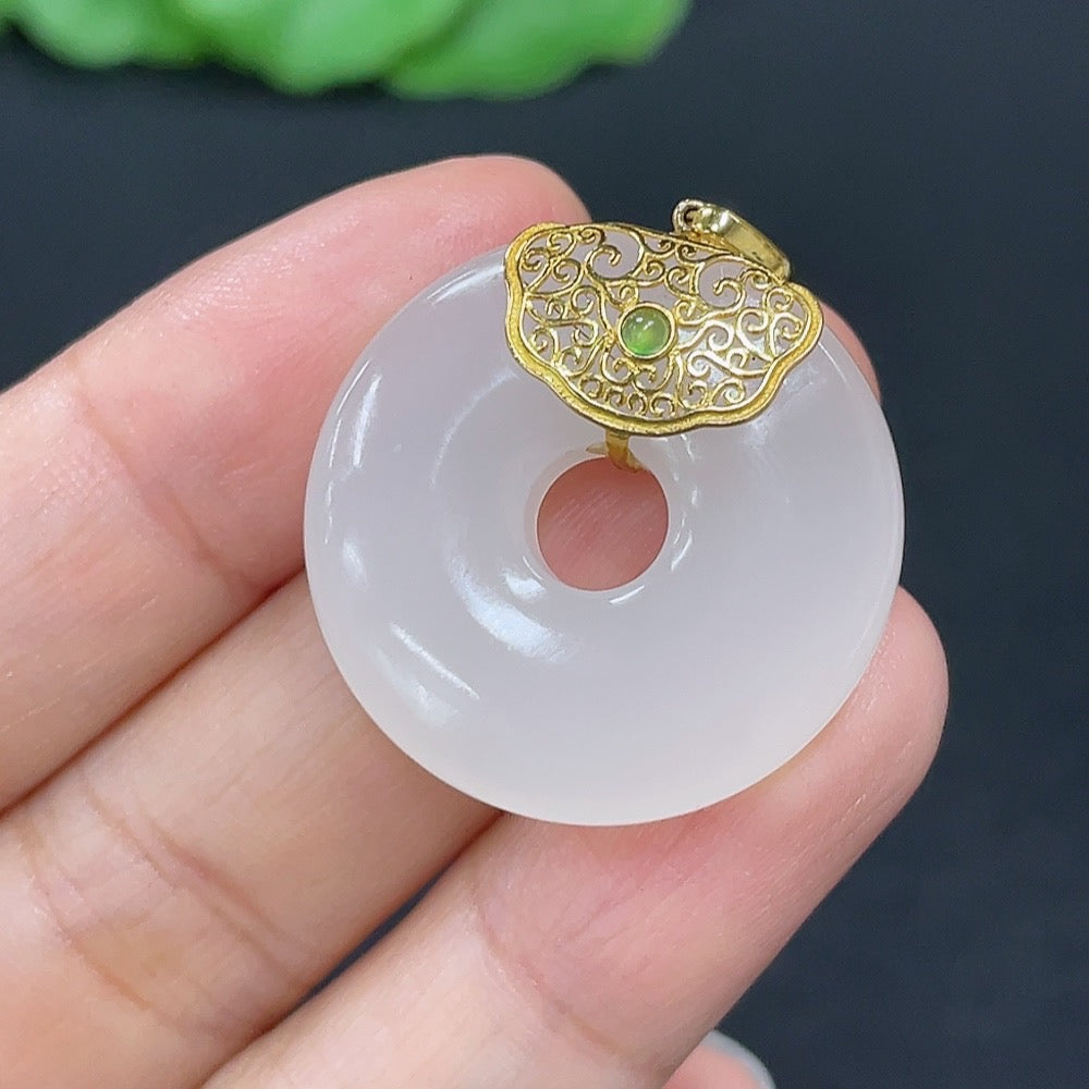 Hetian jade inlaid pendant donut necklace with 18K gold setting, featuring a smooth jade surface and elegant design.