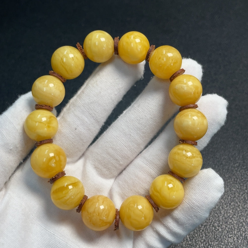 Huiliu Amber Beeswax Bracelet with 15.6mm amber beads, natural and polished, showcasing warm golden tones and smooth surface.