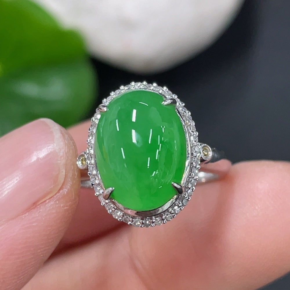 Jadeite cabochon ring in 18K gold with diamond accents, size 9, featuring a smooth green jade stone and elegant gold band.