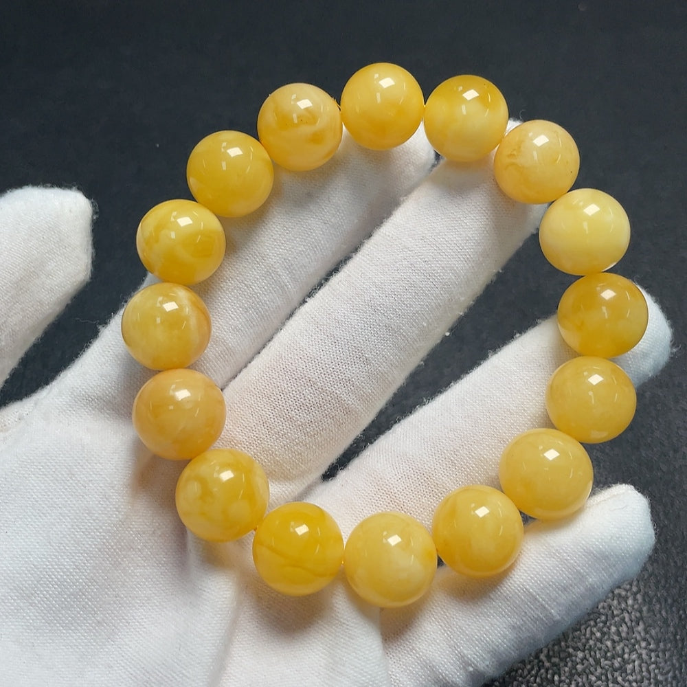 Amber beeswax bracelet with partial visible repairs, total weight approximately 18.25g, size about 12.6mm