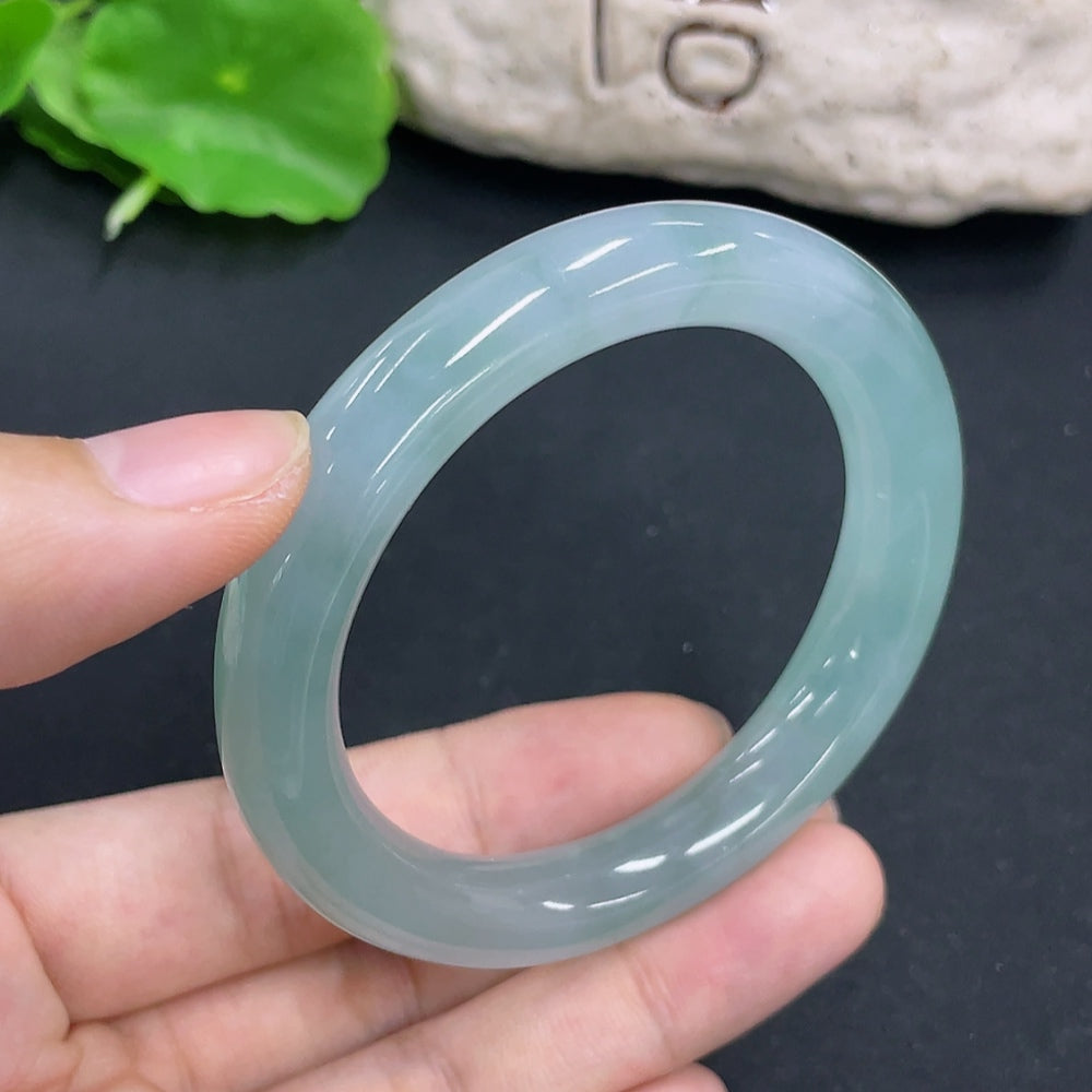 HKHQ Jadeite round bangle with size 50.6 and 47.4g, showcasing smooth, polished jadeite jewelry on a plain background.