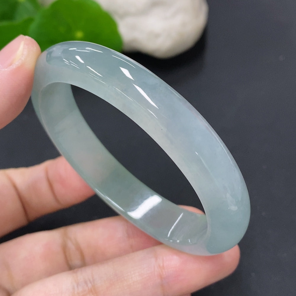 Jadeite oval bracelet featuring smooth, polished green jade stones, crafted by HKHQ, displayed on a neutral background.