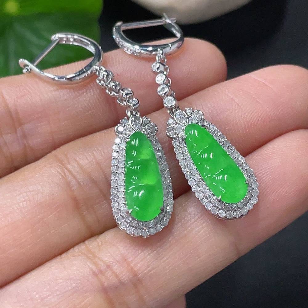 Jadeite earrings with 18k gold and diamond accents, displayed against a neutral background, showcasing their elegant design.