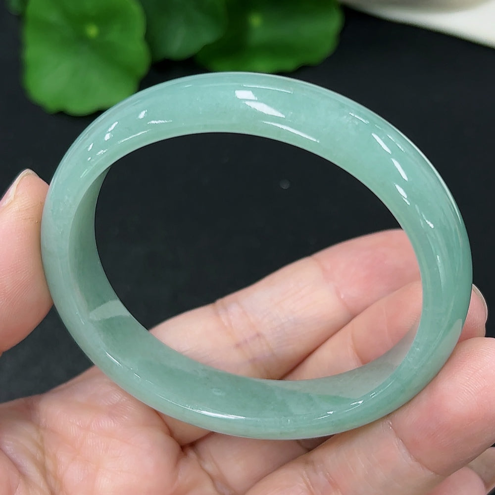 HKHQ jadeite oval bangle in size 53.2 with a polished green finish, weighing 37.4g, showcasing its smooth, elegant design.