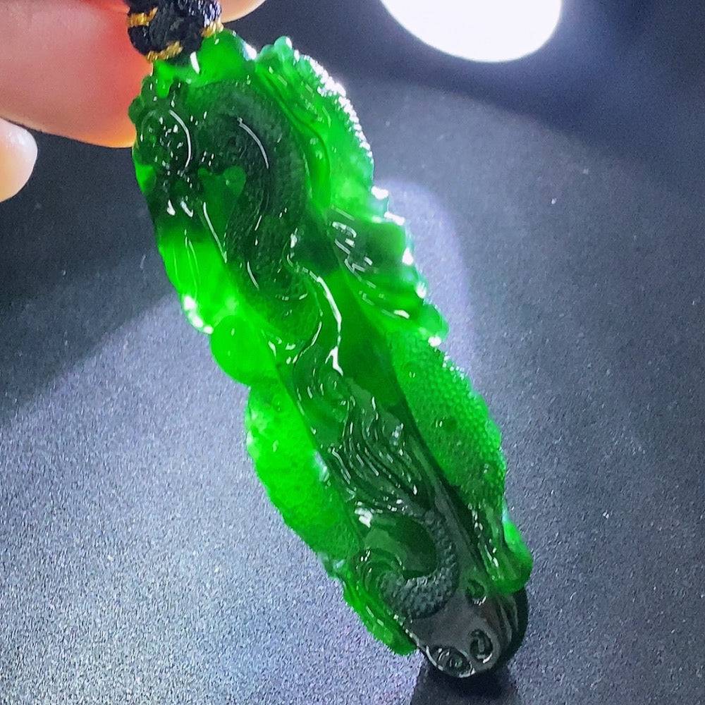 Huiliu Jadeite pendant with dragon plaque and rope, showcasing intricate carved jade design on a smooth, polished surface.