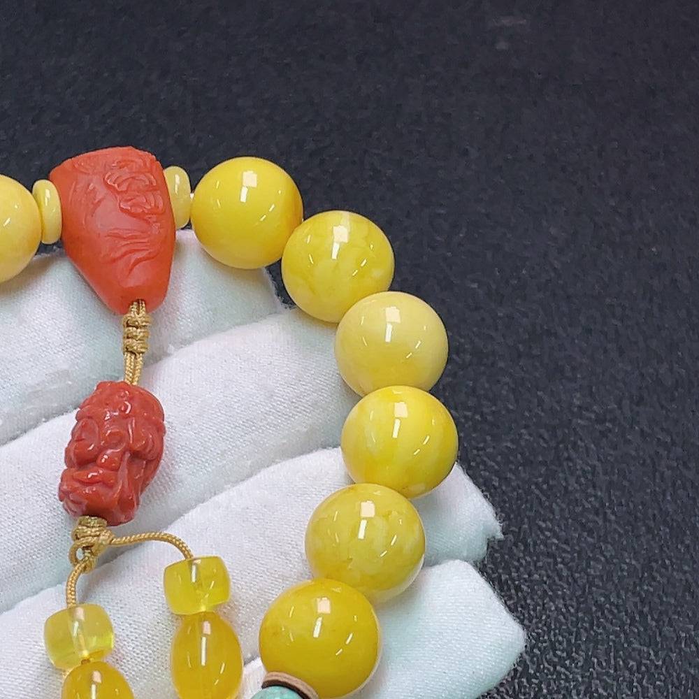 HUILIU HQ amber bracelet with 13mm red agate beads and beeswax accents, crafted with natural-looking amber and gemstones.