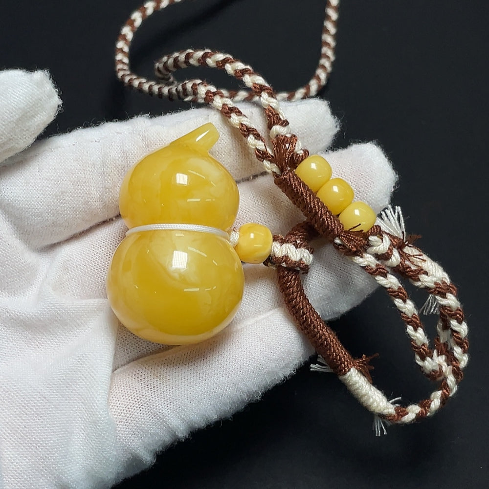 Amber Beeswax Pendant necklace by HKHQ featuring a warm, natural beeswax pendant on a simple cord.