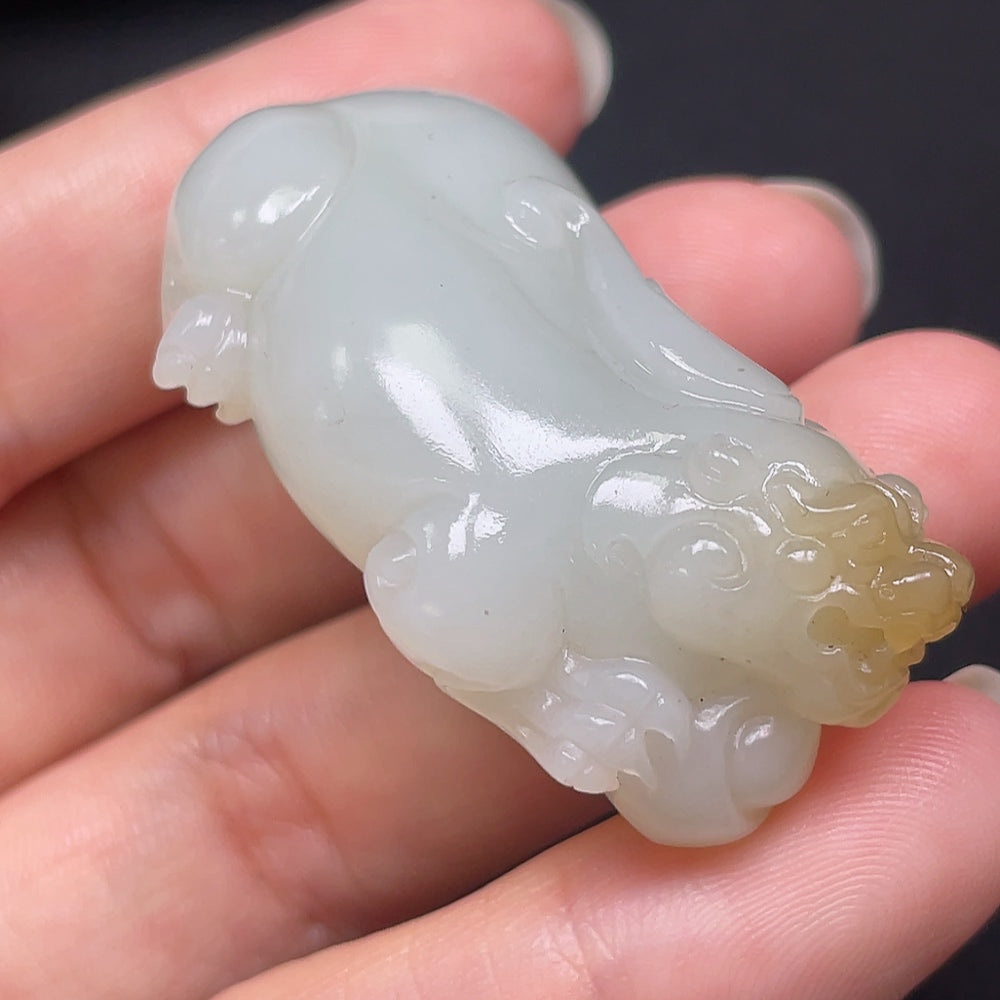 Hetian jade Pixiu pendant from HKHQ, carved in traditional style, weighing approximately 73.49g, showcasing intricate jade craftsmanship.