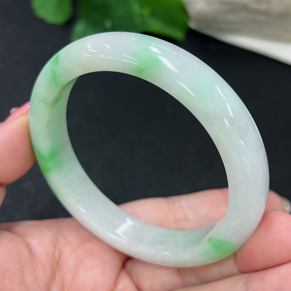 HKHQ jadeite round bangle, size 56, smooth polished surface, showcases vibrant green jadeite gemstone bracelet on a neutral background.