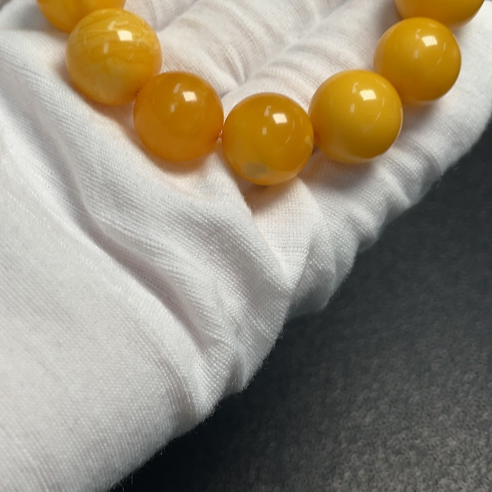 Huiliu Amber Beeswax Bracelet with 14.5mm beads, natural amber jewelry, certified Huiliu HQ bracelet on a neutral background.