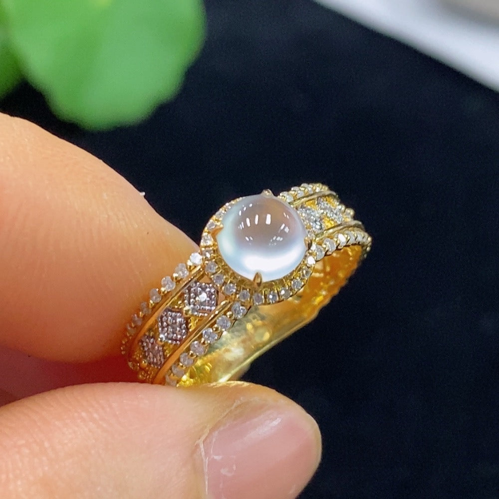 HUILIU HQ Jadeite cabochon ring with diamond accents, featuring polished green jade stone and intricate metal band design.