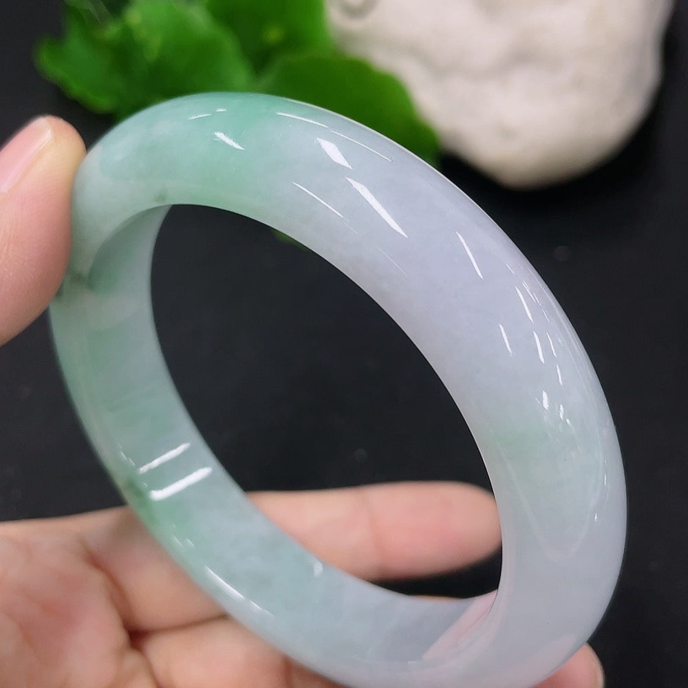 HKHQ jadeite round bangle in size 56, weighing 62.44g, showcasing a smooth, polished jadeite bracelet on a neutral background.