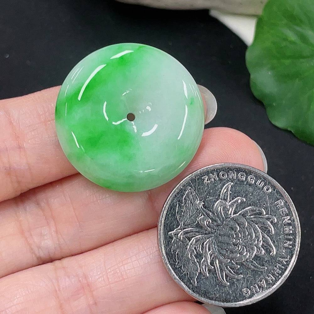 Jadeite Peace Knot pendant from HUILIU HQ, showcasing a smooth, polished jade pendant with intricate knot design on a neutral background.