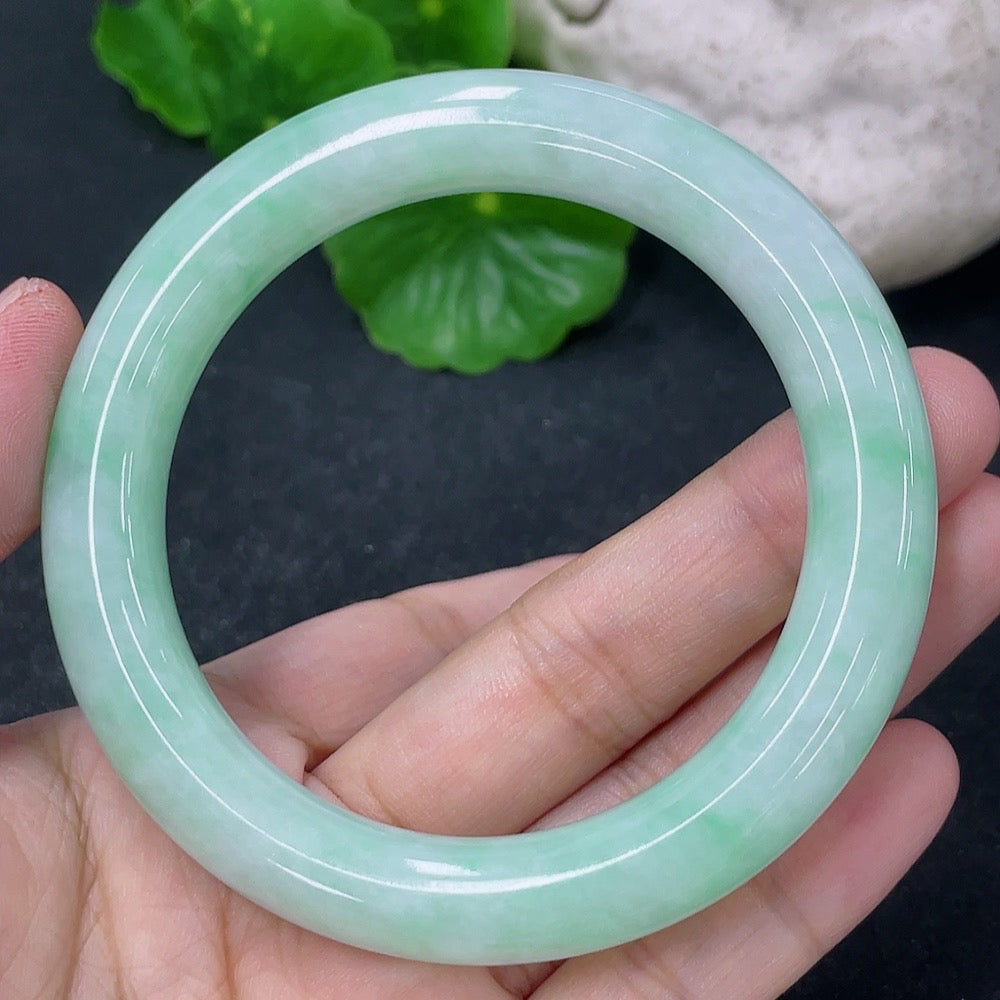 HKHQ jadeite round bangle, 53.5mm, weighing approx. 55.86g, showcasing smooth, polished green jadeite bracelet design.