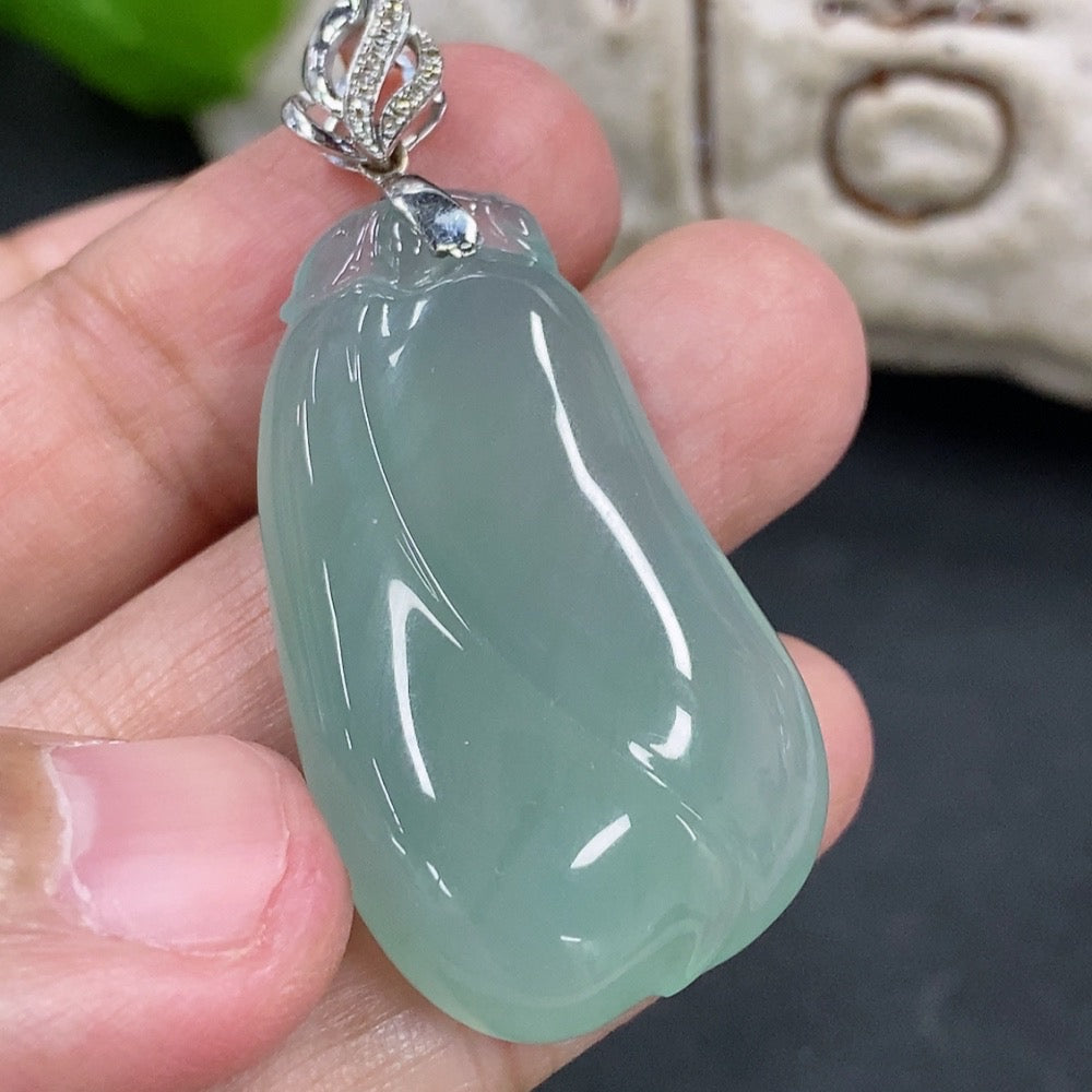 Jadeite pendant featuring a blessing melon design with 18K gold accents and diamond details, hanging on a delicate necklace.