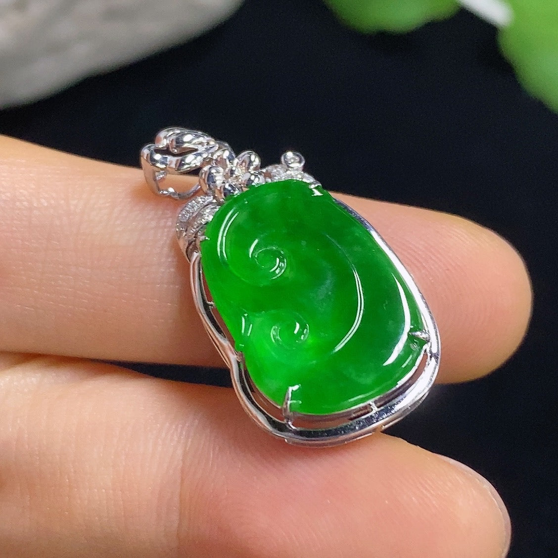 Jadeite Ruyi pendant with 18k gold inlay and diamond accents, showing intricate craftsmanship and polished jade surface.