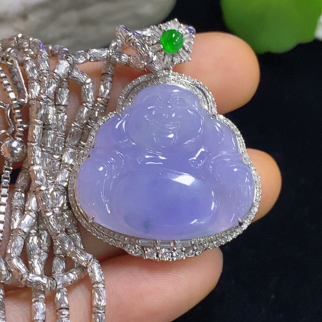 Jadeite Buddha pendant necklace by HKHQ with 18K gold and diamond accents, showcasing a detailed Buddha figure on a chain.