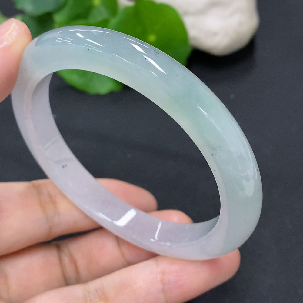 Jadeite round bangle in size 56.7 with an approximate weight of 44g, showcasing smooth, polished jadeite from HKHQ.