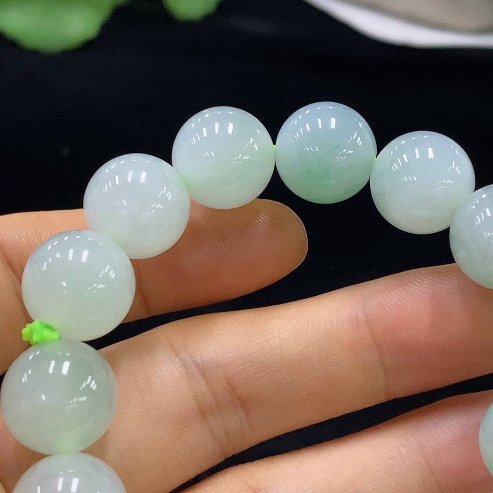 Huiliu Jadeite bracelet with 12.8mm beads, featuring smooth, polished green jade stones on a white background.