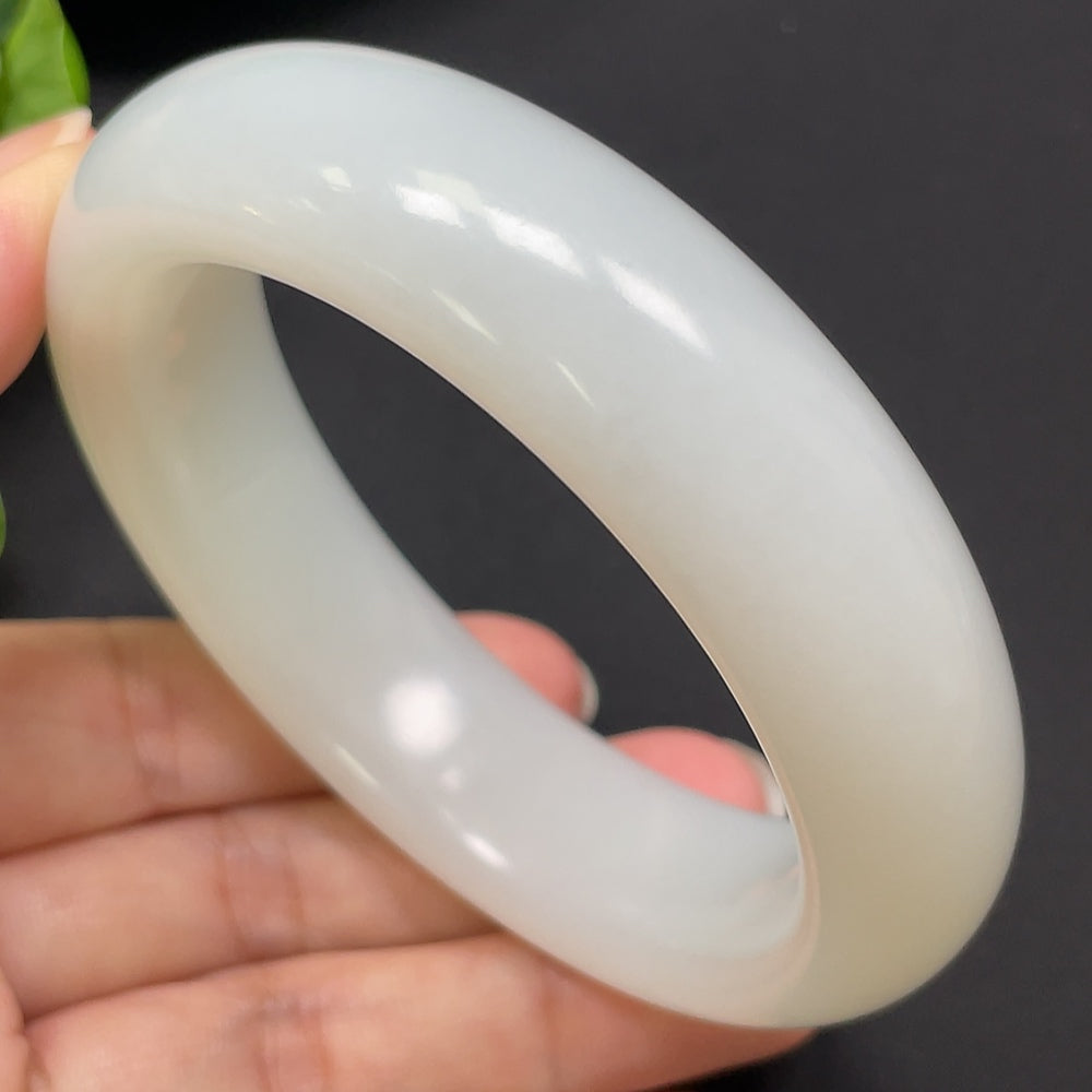 Round Hetian Jade bangle bracelet in size 60.8 with a weight of 104.26g, featuring smooth, polished green jade from HKHQ.