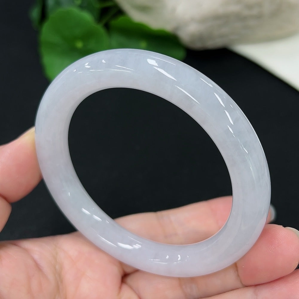 Jadeite round bangle with size 55, weighing approximately 53.33g, featuring smooth, polished jade surface and vibrant green color.