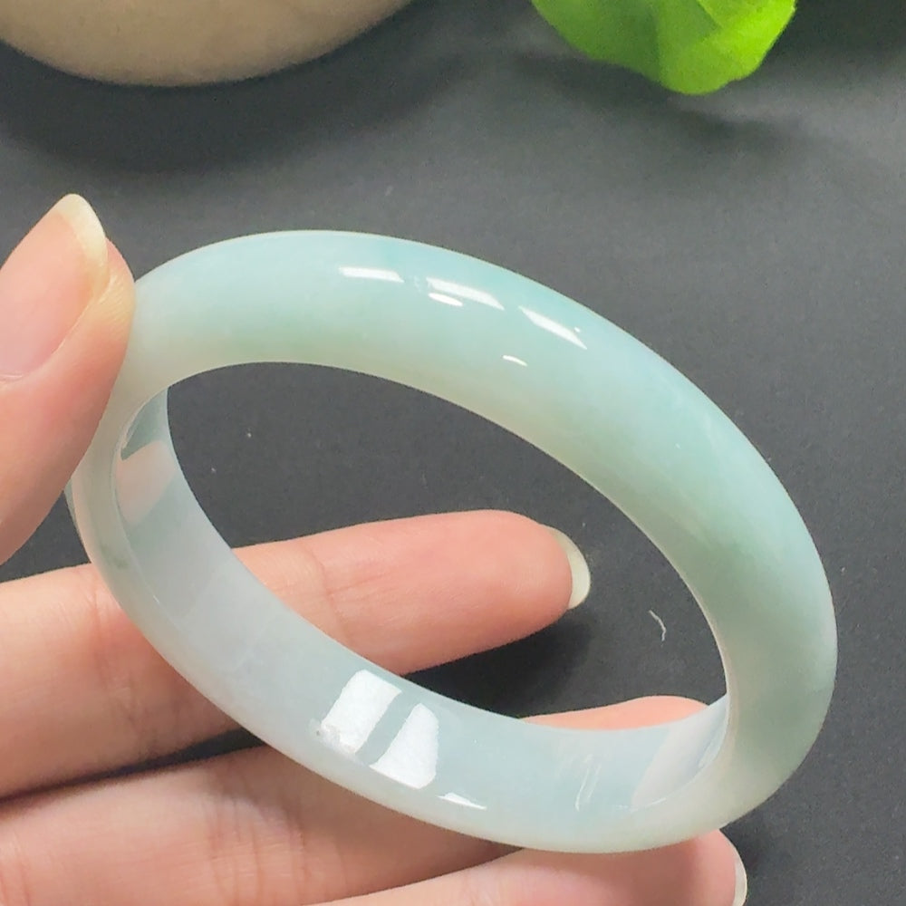 Jadeite round bangle with size 56.9 and weight 51.56g, crafted by HKHQ, showcasing smooth, polished jade surface.