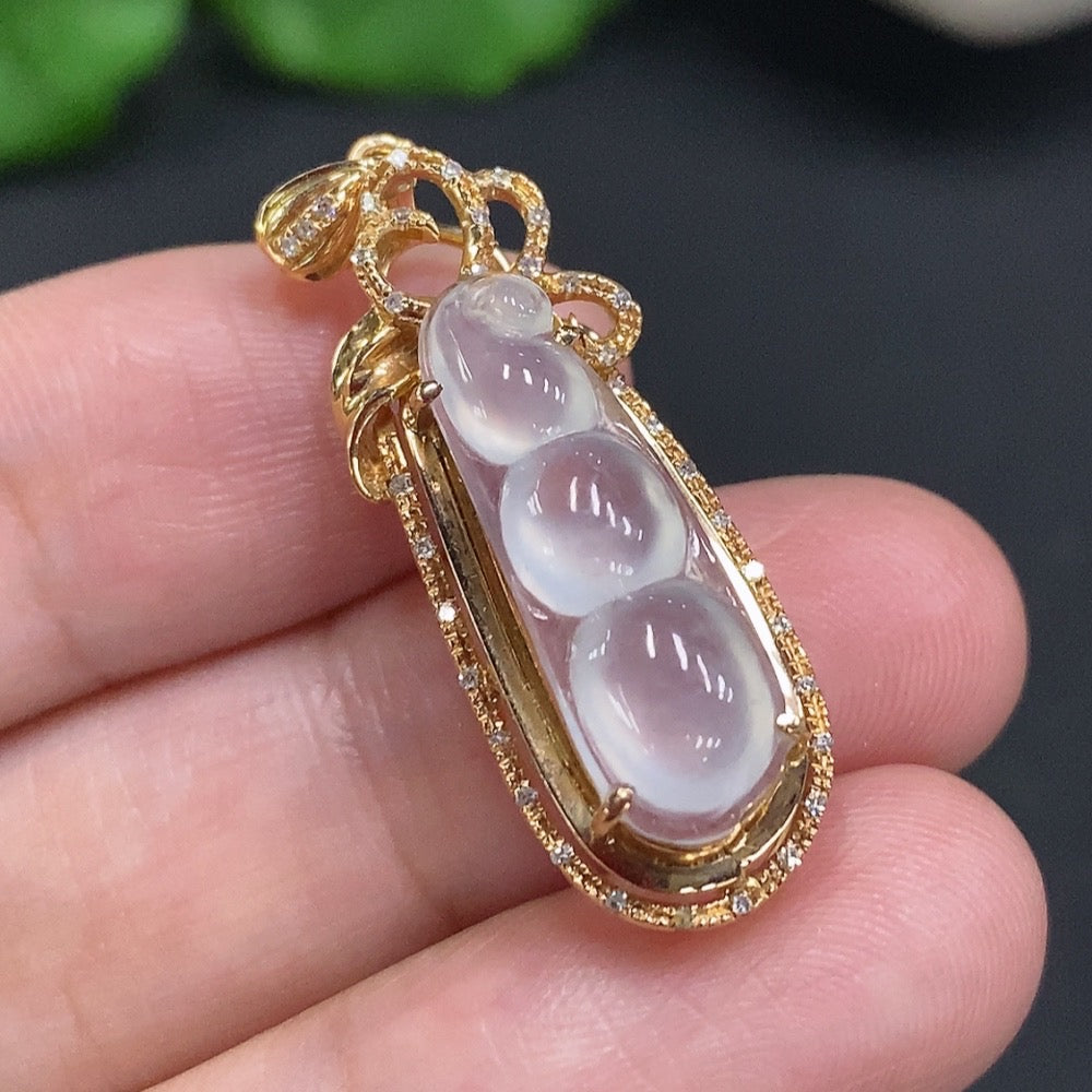 Jadeite lucky bean pendant with 18k gold accents and diamond details, showcasing smooth green jade and intricate craftsmanship.
