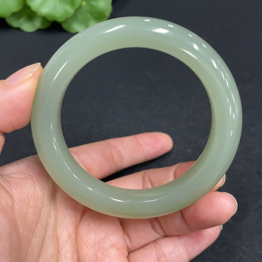 Huiliu certified Hetian Jade round bracelet featuring smooth, polished jade beads on a delicate string, showcasing natural green hues.