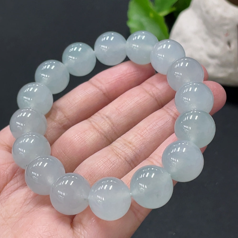 Huiliu certified jadeite bracelet with 13mm smooth, polished jade beads on a flexible string.