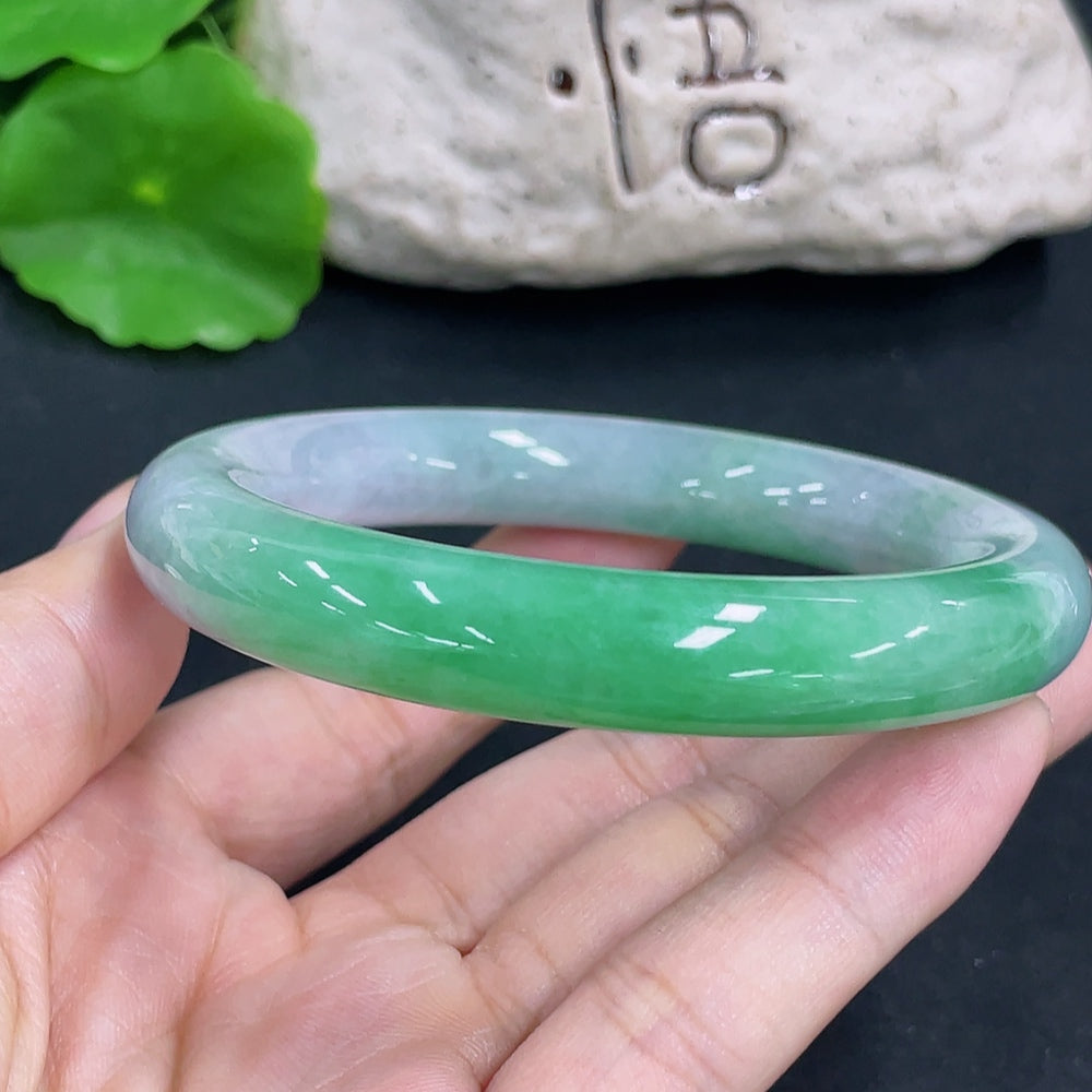 HKHQ jadeite round bangle with 64.9g weight and size 55.8, featuring smooth, polished green jade surface and elegant circular design.