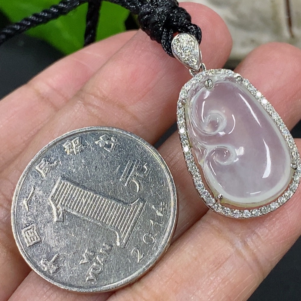 Jadeite Ruyi pendant with 18k gold accents and diamond details, featuring a jadeite stone, on a rope chain.
