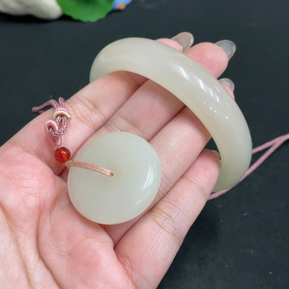 Hetian jade pendant and matching circle bracelet from HUILIU HQ featuring smooth, polished jade jewelry with intricate carvings.
