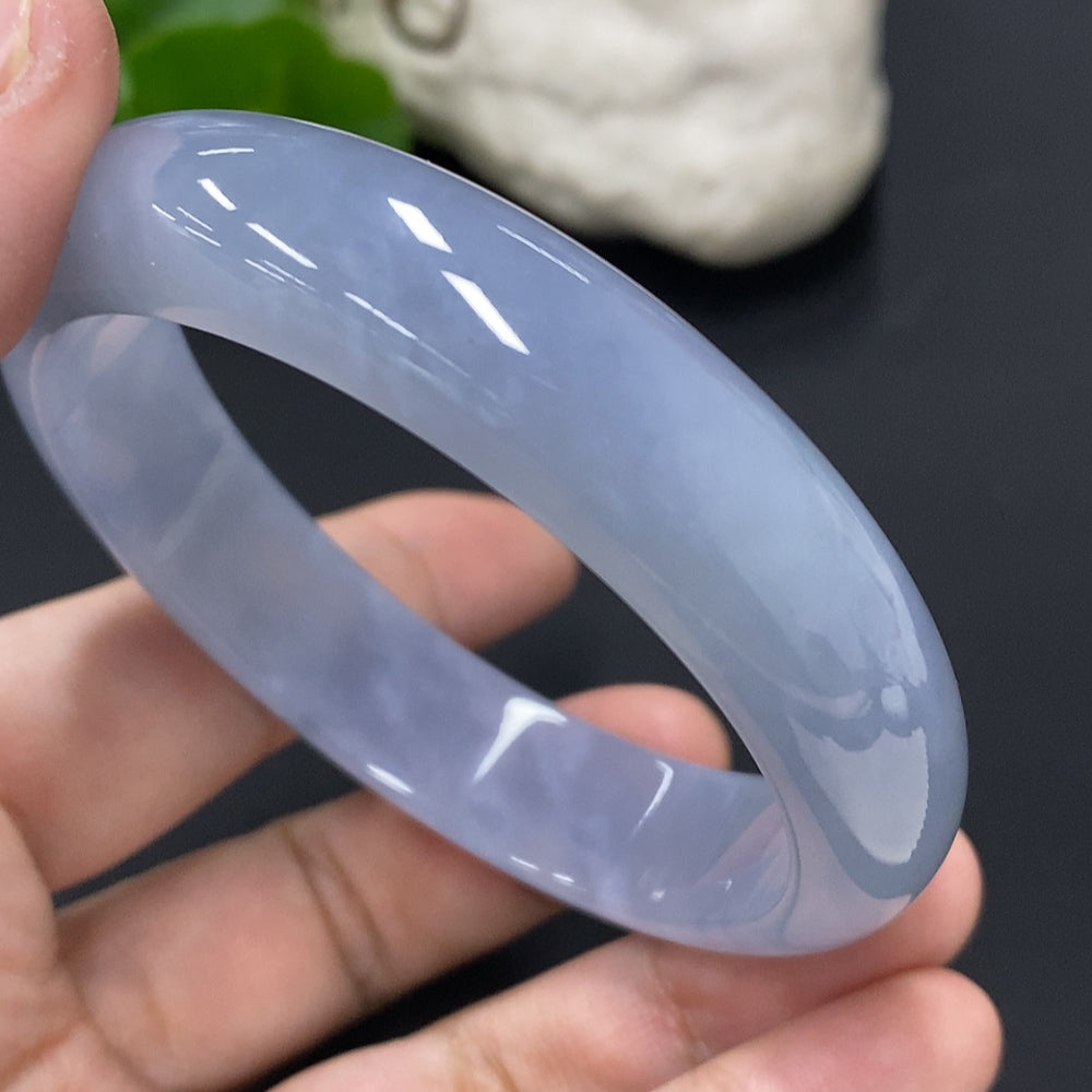Jadeite round bangle with a size of 57.3mm and weight of 56.3g, crafted by HUILIU HQ, showcasing smooth jade surface and rounded shape.