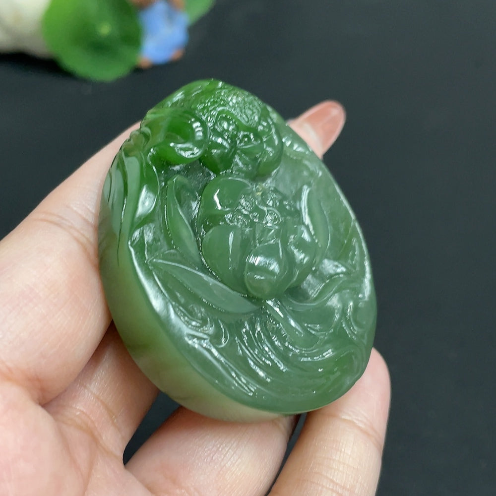Huiliu Hetian jade Jasper pendant featuring a lotus and fish design symbolizing abundance and prosperity.