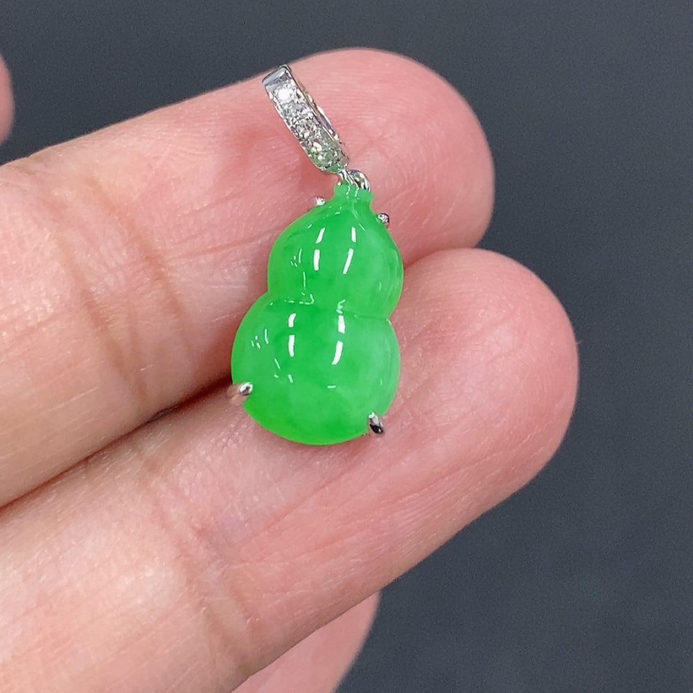 Jadeite gourd pendant with 18K gold and diamond accents, featuring intricate inlay work and a polished jade surface.