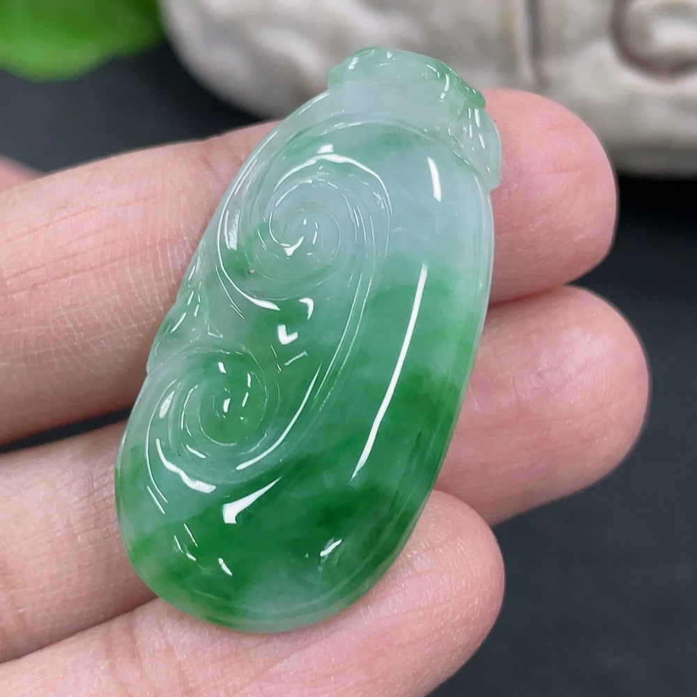 HKHQ Jadeite Ruyi pendant necklace featuring a polished green jadeite ornament on a delicate string.