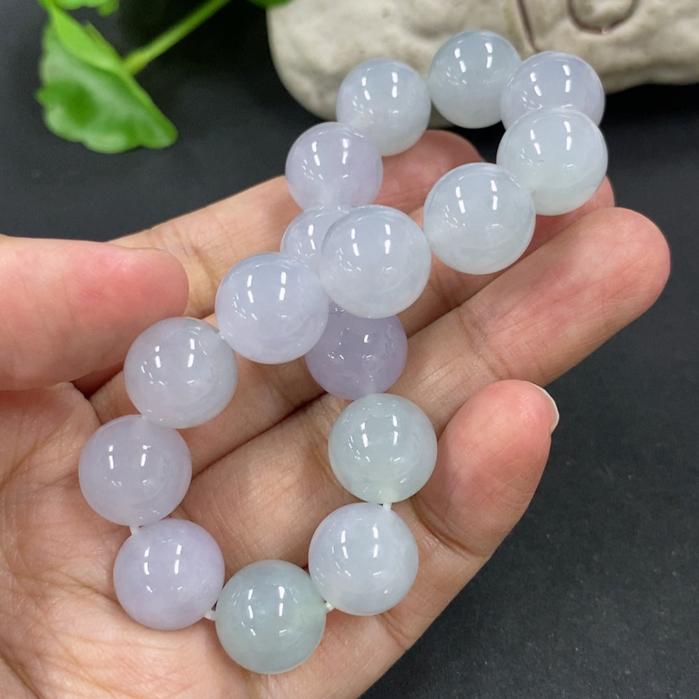 HKHQ jadeite bracelet with 12mm beads, approximately 49.7g, showcasing smooth, polished green jadeite stones.
