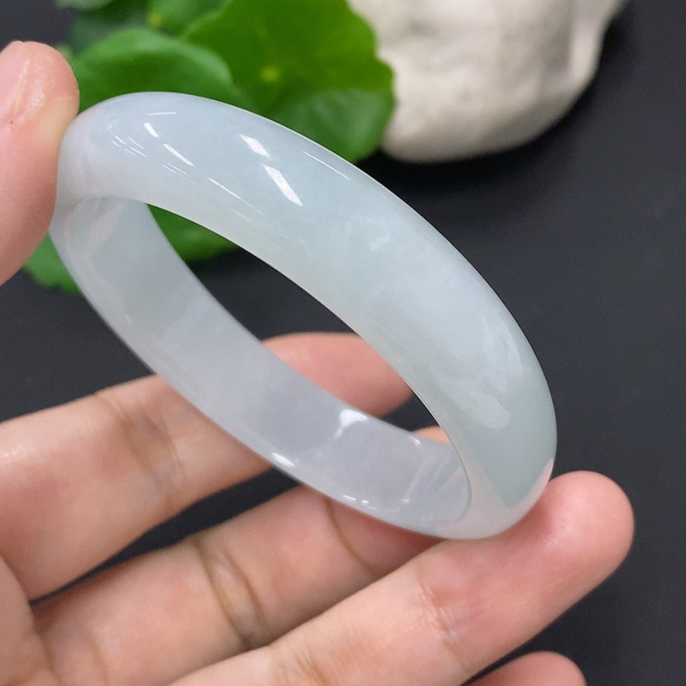 Huiliu HQ jadeite concubine bracelet with intricate carvings, featuring a smooth green jade surface and detailed craftsmanship.