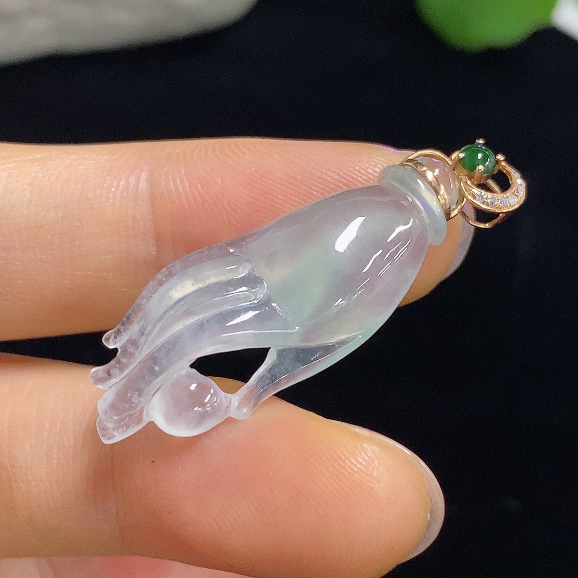 Jadeite pendant with diamond accents in 18k gold, featuring a polished green jade stone, on a delicate gold chain.