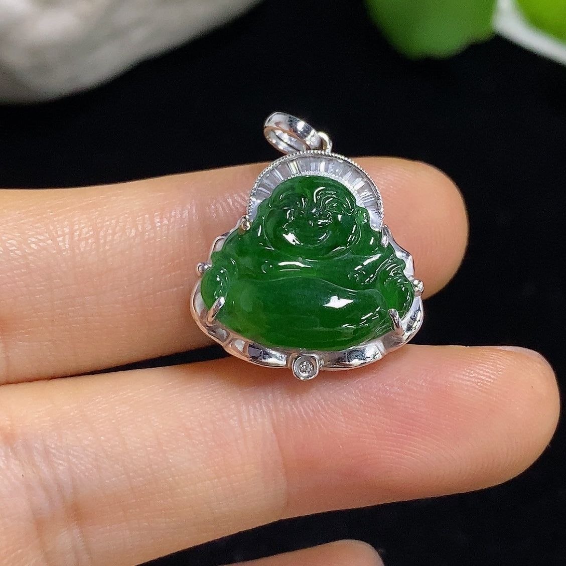 Jadeite pendant featuring Buddha design with 18K gold and diamond accents, displayed on a necklace chain.