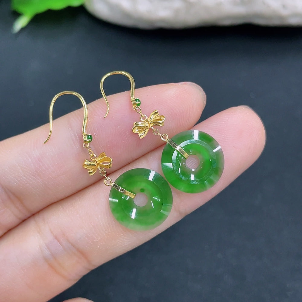 Elegant jadeite earrings with 18k gold accents, weighing approximately 1.3g, showcasing smooth, polished jade stones.
