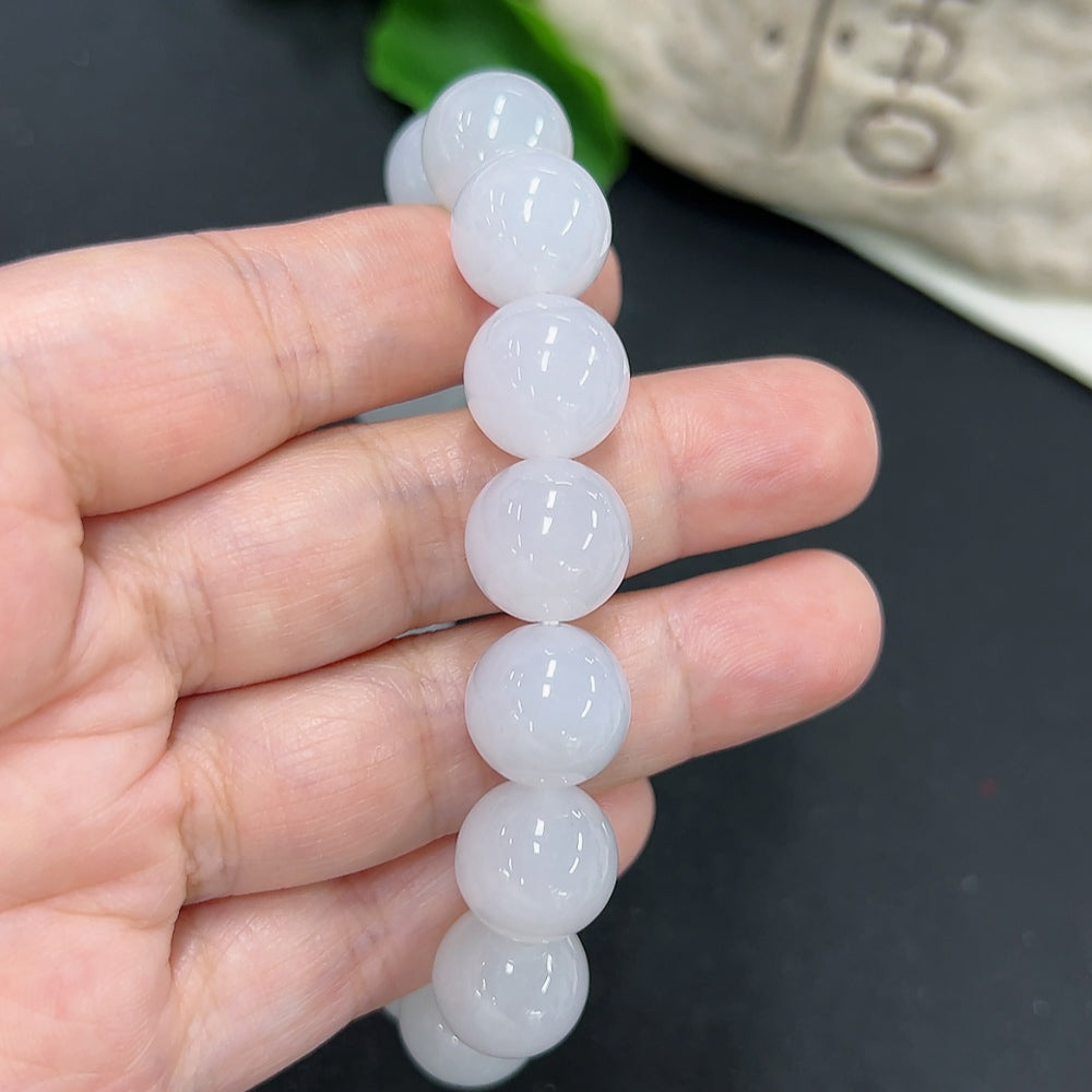Jadeite bracelet with 12.8mm beads, crafted by HKHQ, showing smooth, polished jadeite stones and a secure clasp.