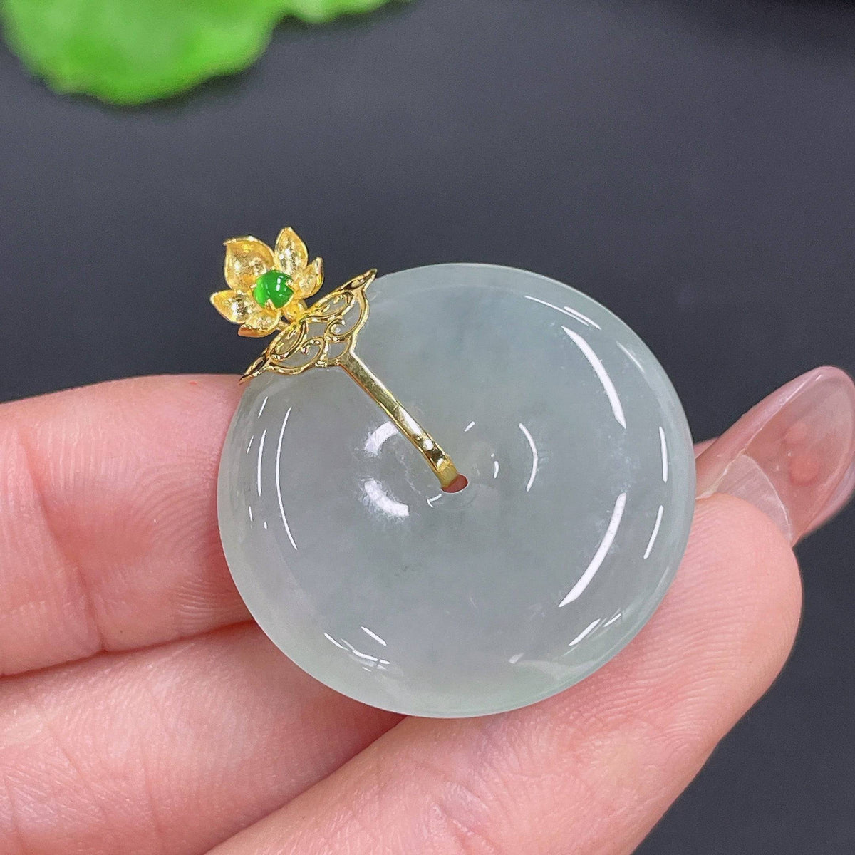 Huiliu Jadeite Peace Knot Pendant featuring a smooth, polished green jade pendant with intricate knot design.