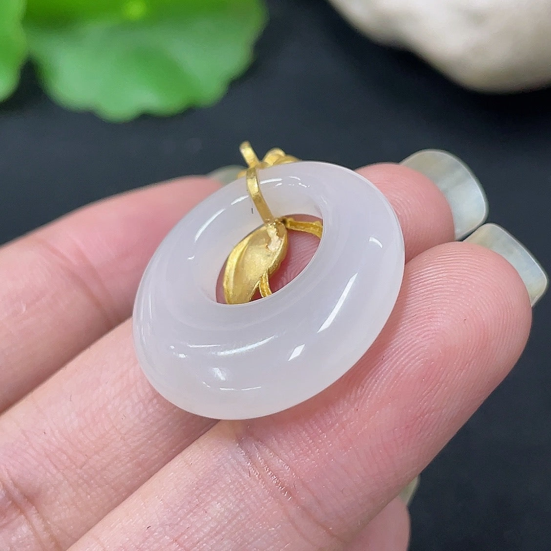Hetian Jade inlaid pendant on 18K gold necklace, crafted by HKHQ, showcasing a smooth jade stone with gold accents.